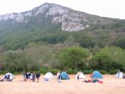 Tents at the foot of a small mountain