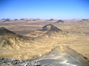 Volcanic mountains have sprinkled iron ore in a thin layer over the Black Desert