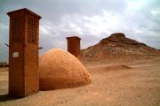 Wind towers of an old Zoroastrian hamlet and the Tower of Silence in the background